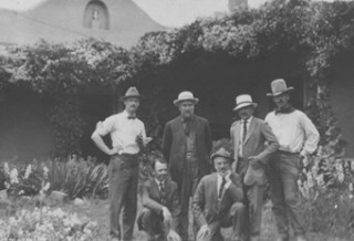 PHOTO CREDIT: The six founding members of the Taos Society of Artists in Virginia Walker Couse’s garden, 1915 (L-R, E.L. Blumenschein, O.E. Berninghaus, E.I. Couse, J.H. Sharp, B.G. Phillips, and W.H. Dunton) Photo credit: The Couse-Sharp Historic Site, Taos, NM